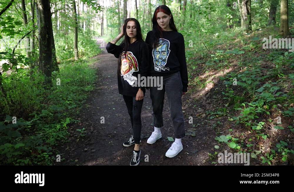 Two young girls standing in the forest Stock Video Footage - Alamy