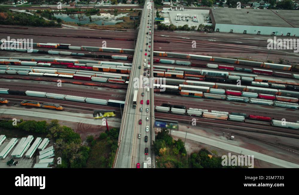 following black semi tractor reefer across the bridge under complex ...