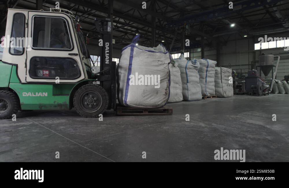 Forklift drives to workshop to load bag of fertilizers Stock Video ...