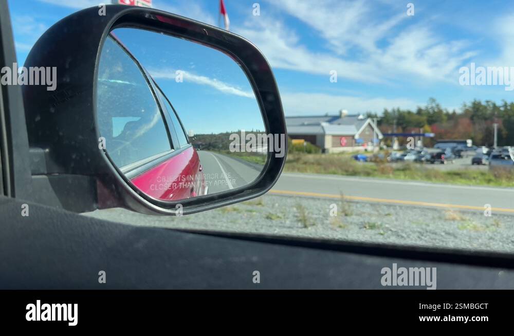 Rear view side window of a car driving in rural Canada, Nova Scotia ...