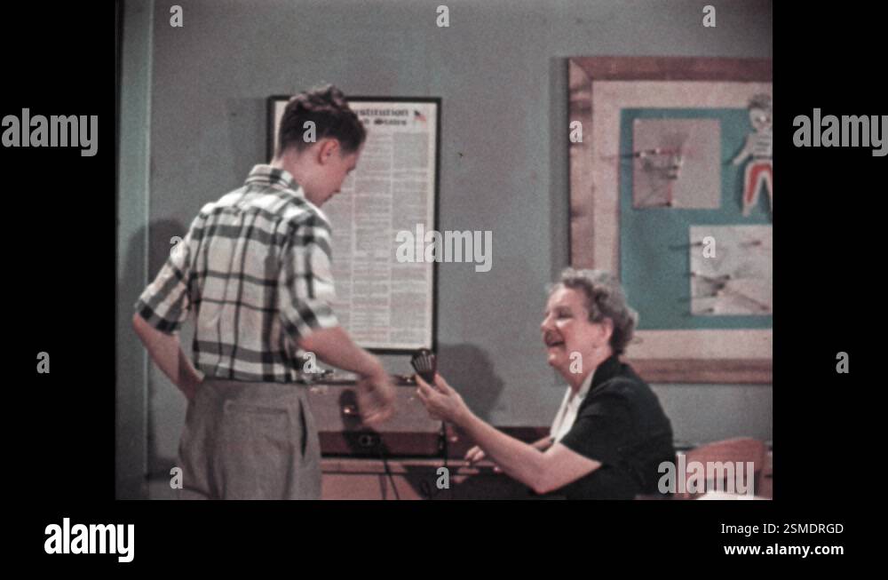 1960s: Boy enunciating his speech. Enthusiastic teacher hands the boy a ...