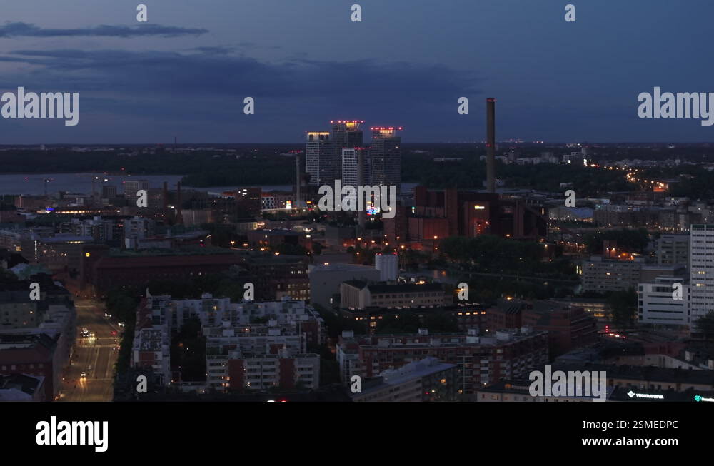 Fly above night city. Aerial view of high rise buildings with rooftop ...