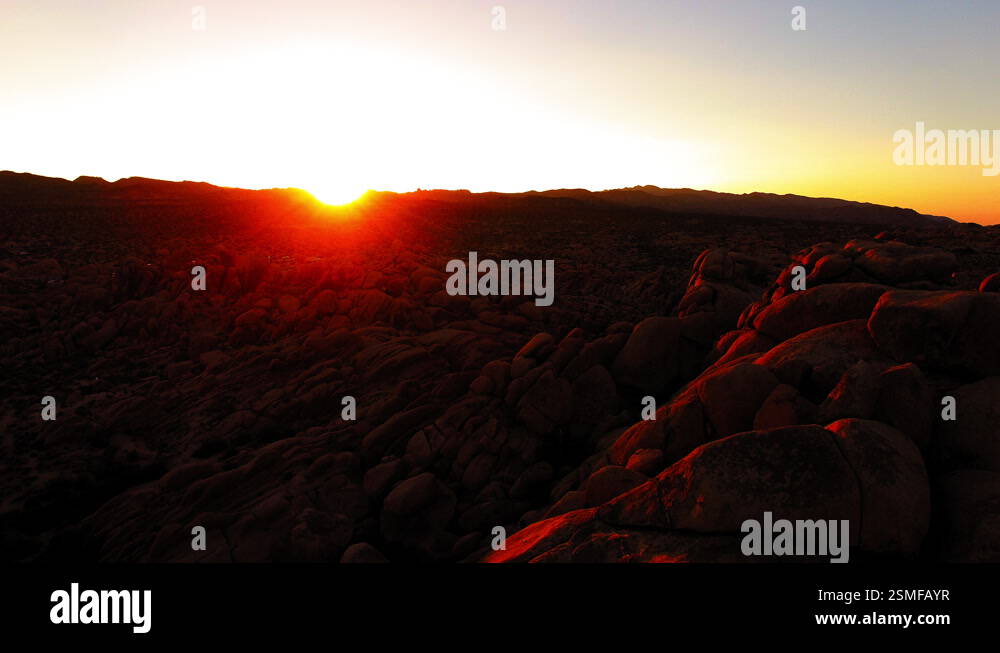 Aerial Panning Tranquil View Of Rocks In Semi Arid Desert Against Clear ...