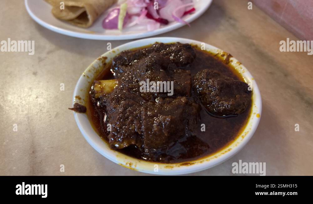 Bengali style mutton curry with roti and onion served in Gol Bari Stock ...
