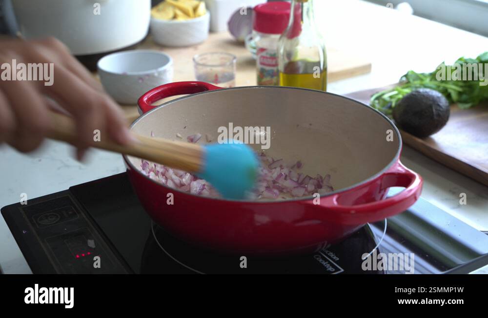 Use a spoon to cook red onions in a pot special ingredients to cook a ...