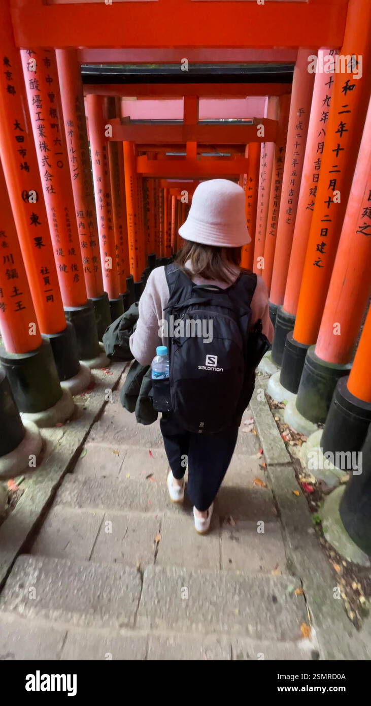 Kyoto, Japan, Tourist Walking Through the Torii Gates at Fushimi Inari ...