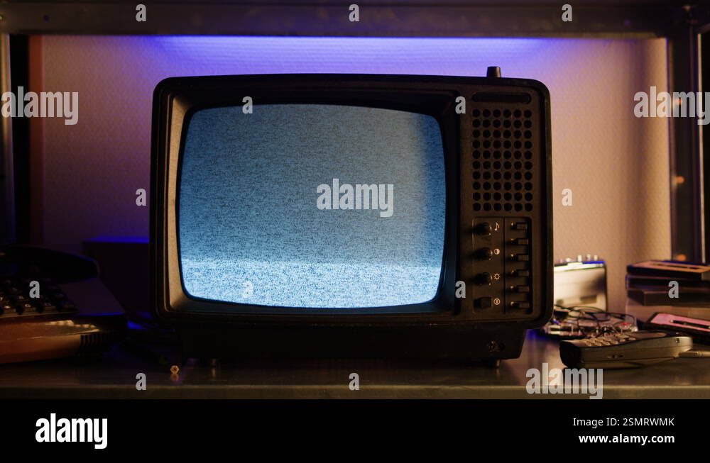 In a nostalgic setup, a retro TV displays static on its screen ...