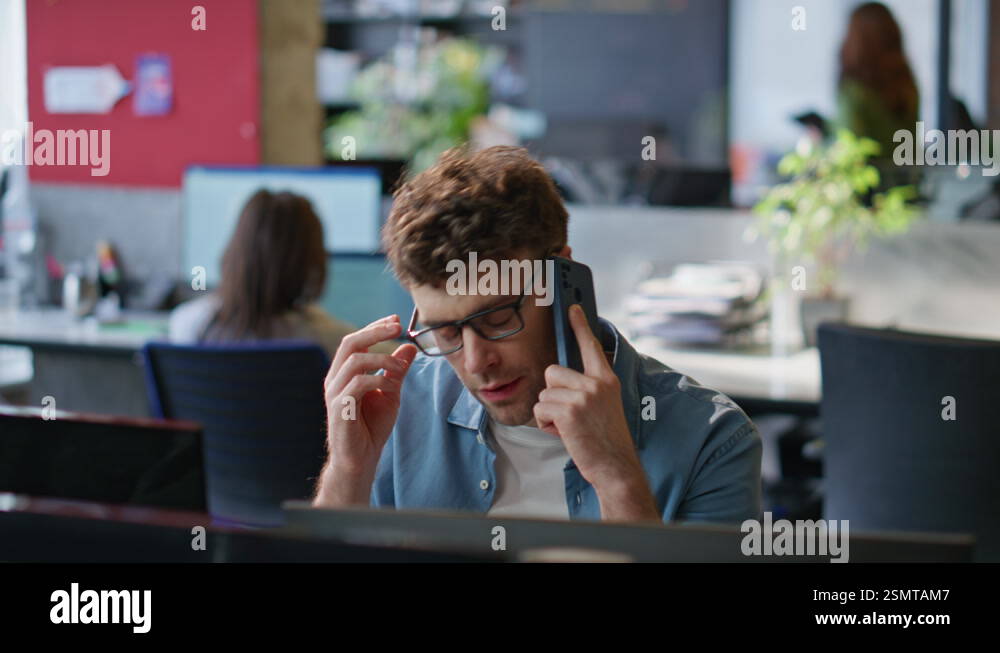 Worried employee calling cellphone at workplace closeup. Upset manager ...