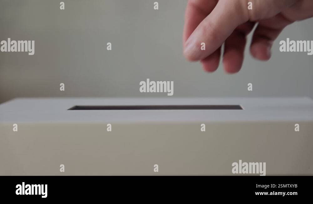 Voter Casting Their Ballot into the Secure Vote Box at the Polling ...