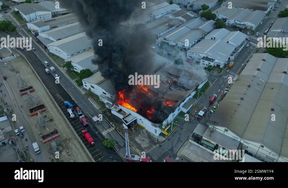 Firefighters battling a fierce blaze at a factory, working to control ...