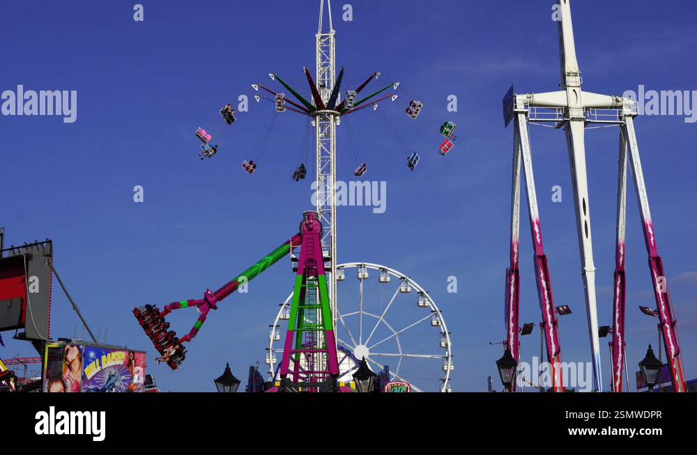 Barry Beach Rides Tall fairground rides at Barry Island Pleasure Park, Wales against a ...