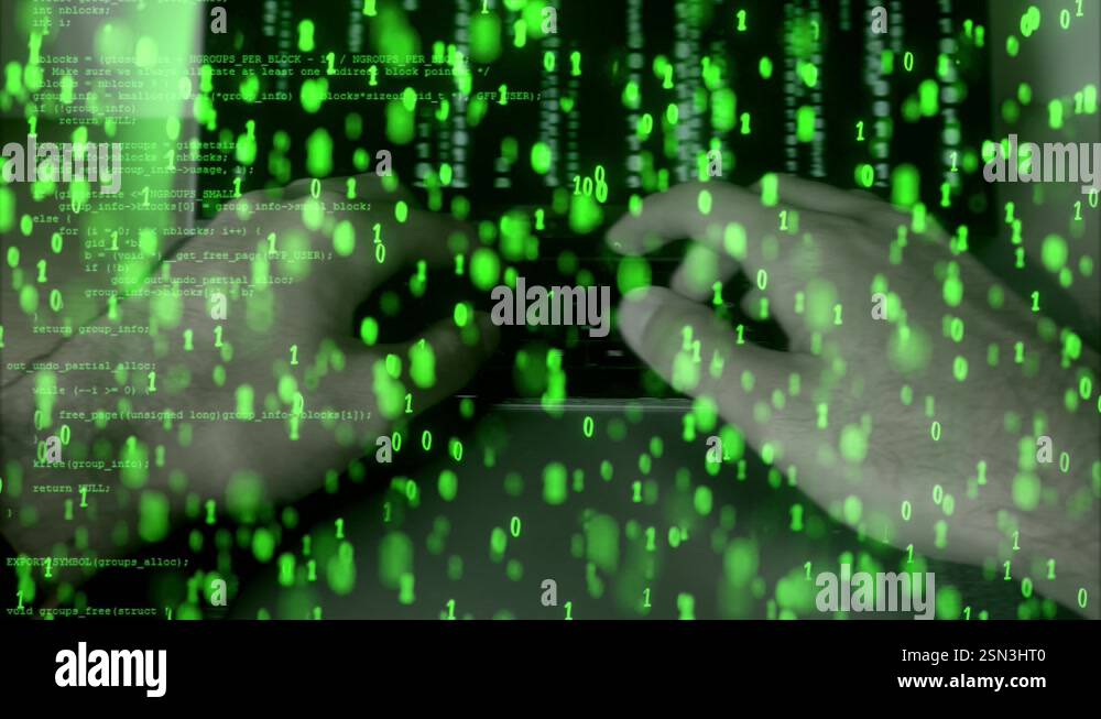 Hacker typing on a laptop with green binary code overlay. Cyber attack ...