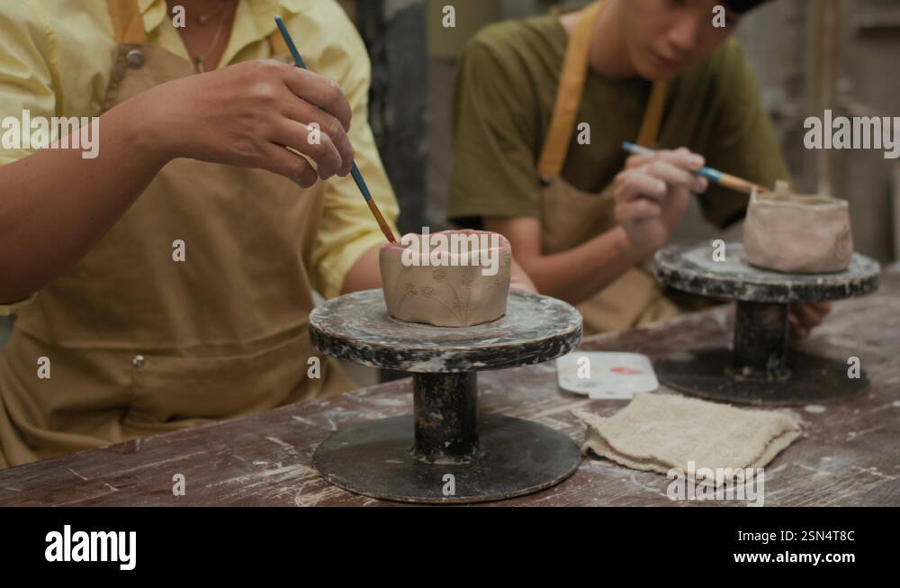 Instructor and Student Painting Handcrafted Clay Cups in Workshop Stock ...