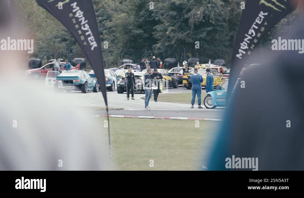 Busy drift race track with sports car and drivers gathering from ...
