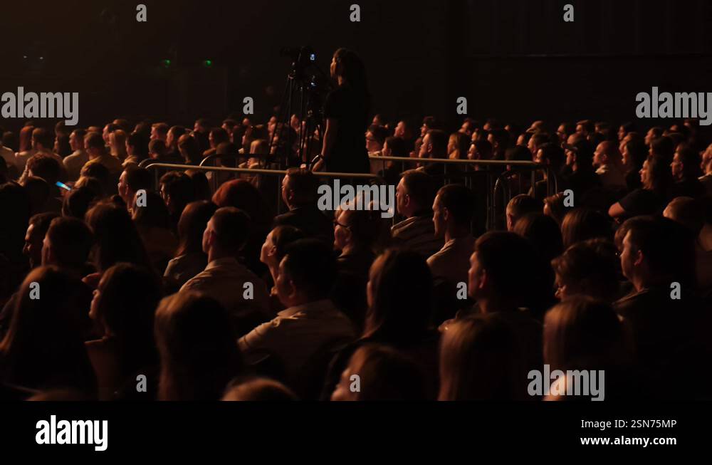 The camera operator films the presenter's performance standing up ...