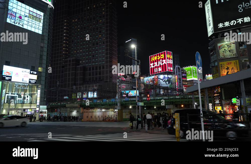 A vivid scene of Shinjuku’s iconic skyline at night, featuring dazzling ...