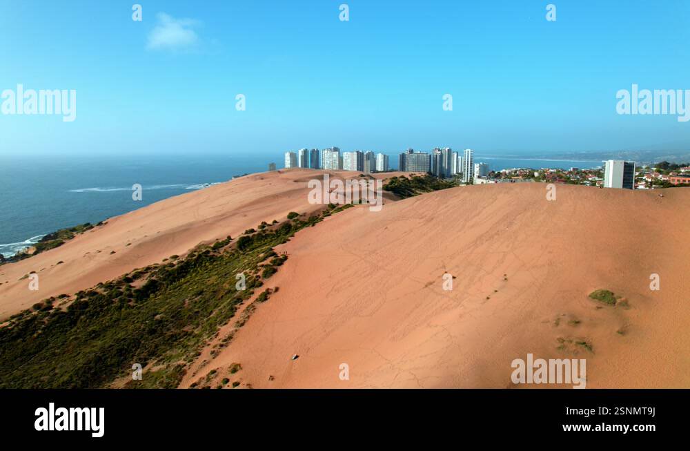 aerial-establishing-of-concon-dunes-next-to-buildings-sea-at-golden