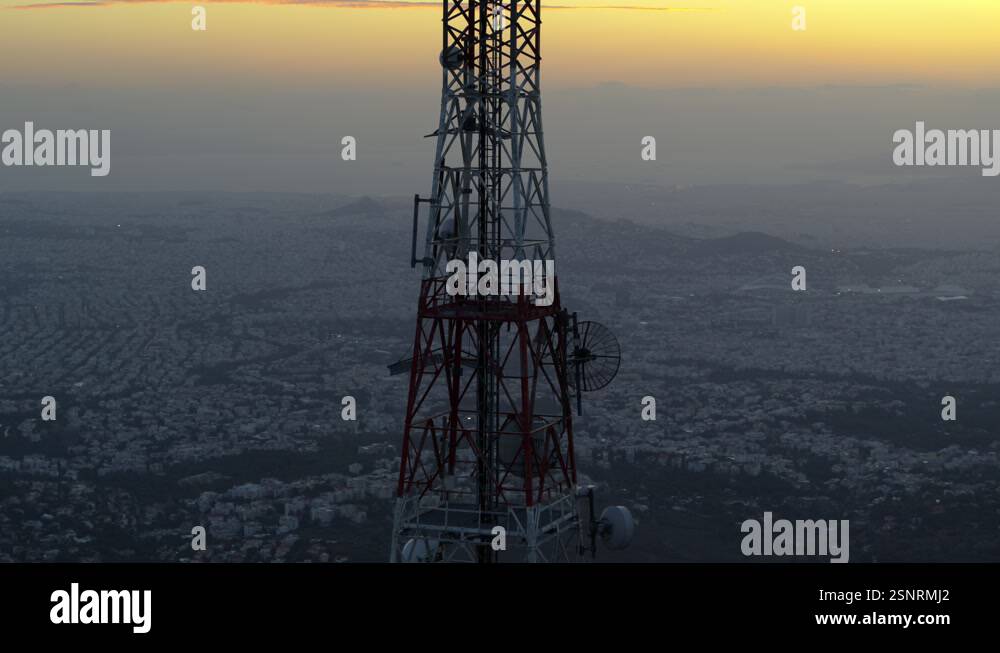Telecommunications Cell Tower on top of mountain with city in the ...