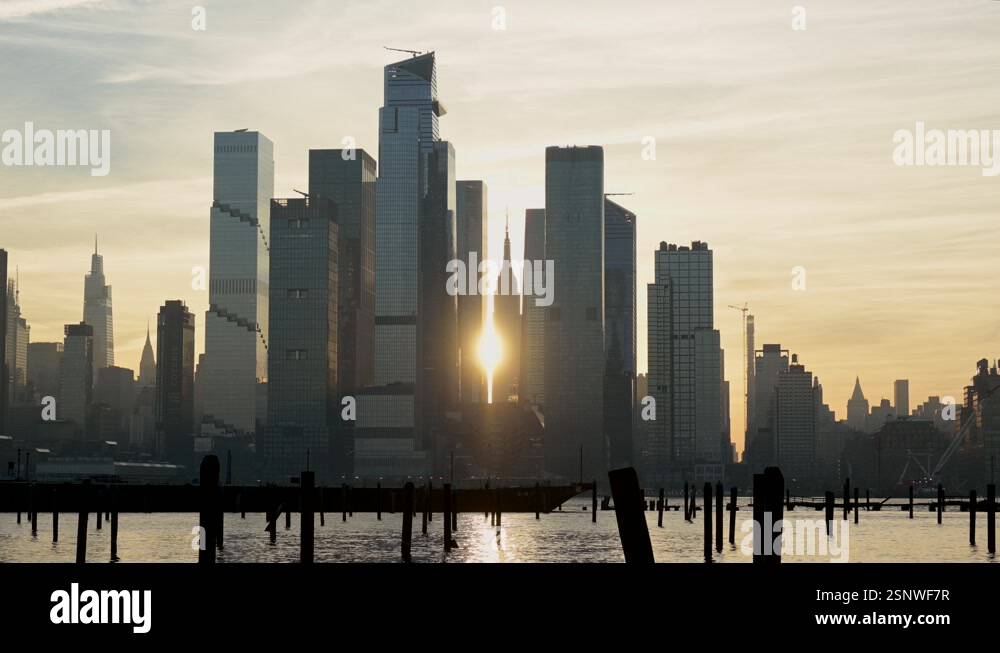 Snwf Sun rising behind skyscrapers of Hudson Yards in midtown Manhattan over ...