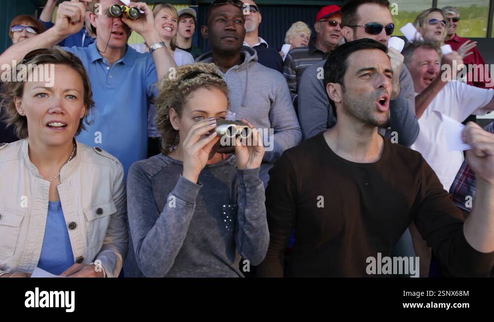Spectators At The Races Enthusiatic crowd of spectators at horse racing or dog track Stock ...