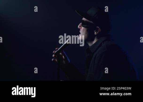 Close up of a rap artist singing on a dark background. 4k high ...