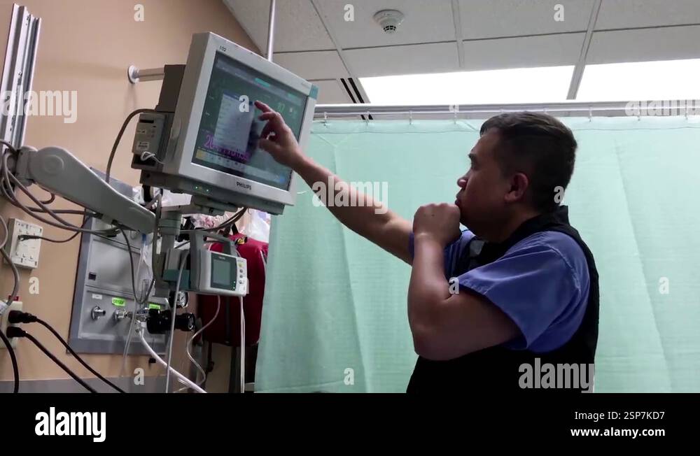 Nurse checking monitor of indications of action of heart and blood ...