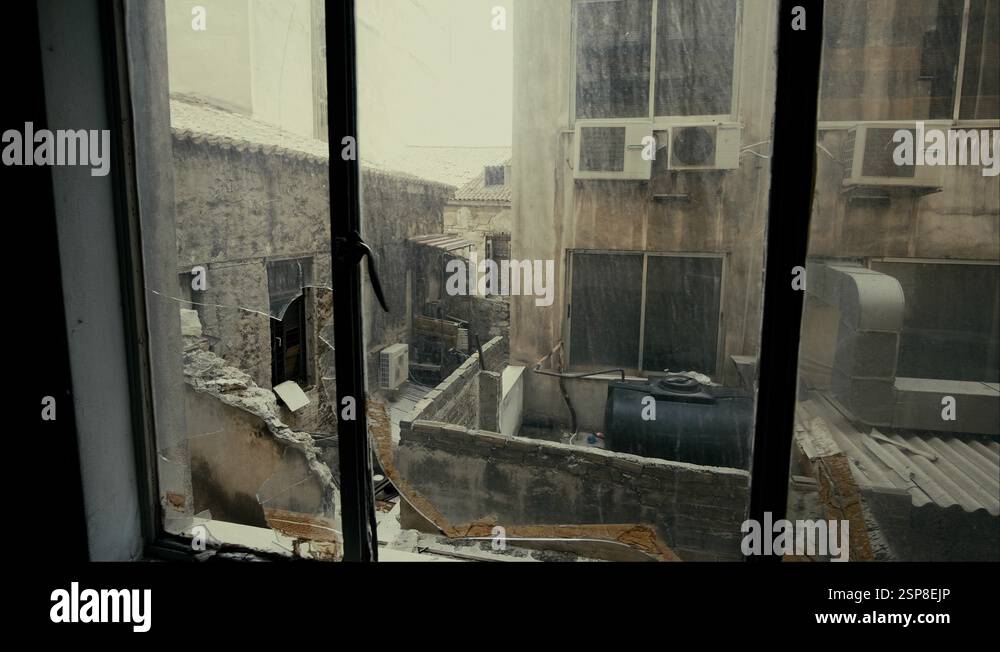 4K Window view at collapsed, half-ruined buildings in ghetto city block ...