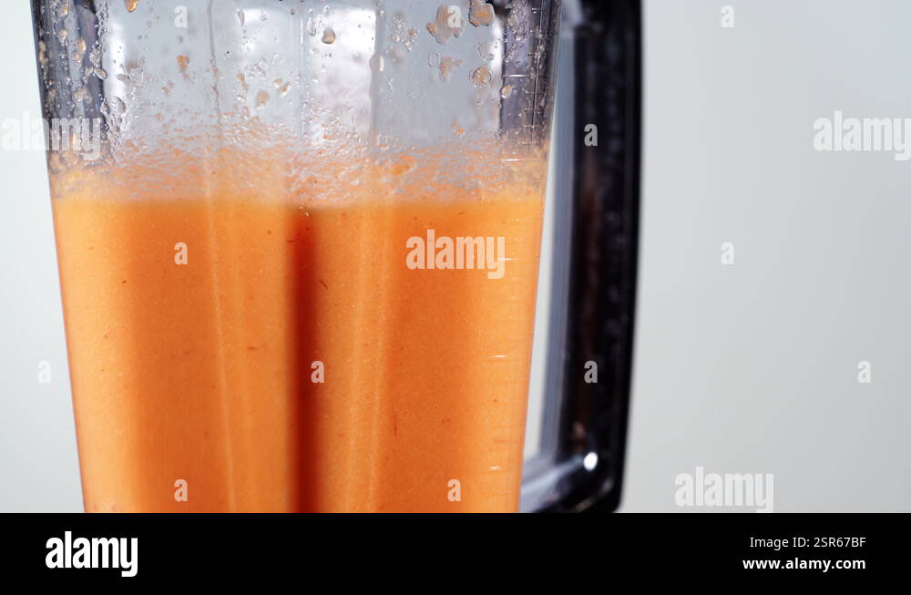 Making carrot shake in blender Stock Video Footage - Alamy