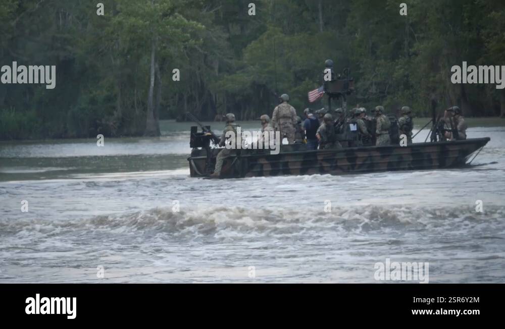 American soldiers firing their machine guns on a river during training ...