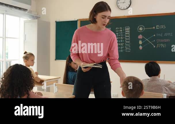 Instructor With Notebook Professional happy teacher collects notebook from cute student while ...