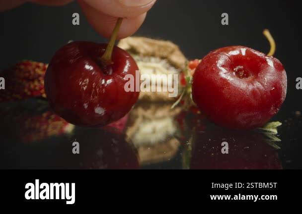 Raspberry Decay Hand Reaching to Pick Up a Small Dried Raspberry Among Wrinkled Cherry ...