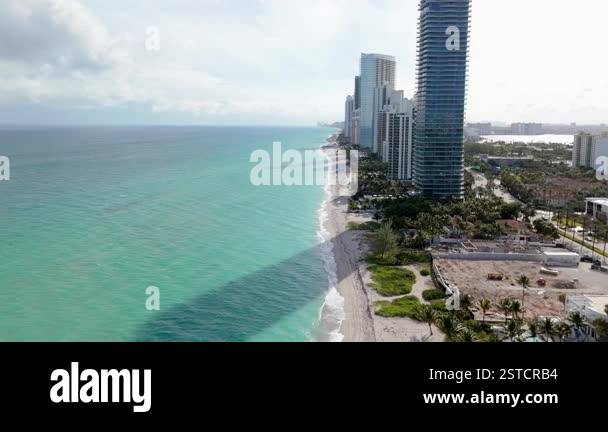 Experience a stunning aerial shot of Miami Beach and its iconic skyline ...