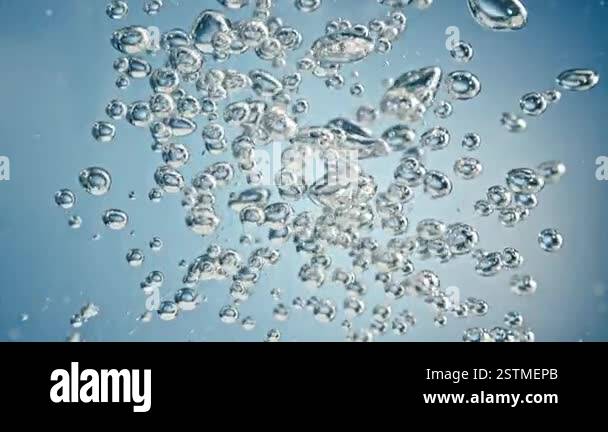 Super Slow Motion Shot of Air Bubbles Rising Up in Water on Light Blue ...