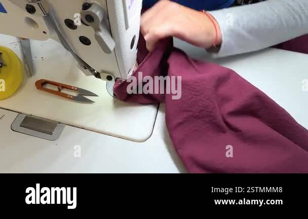Textile worker using a sewing machine to create professional garments ...