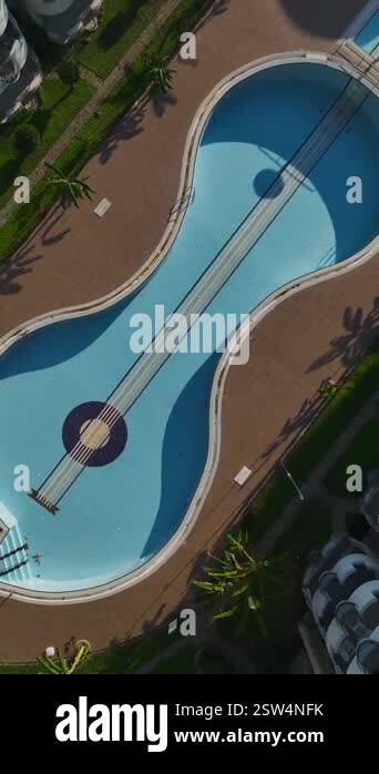 Aerial empty pool and greenery. Vertical footage of a scenic housing ...
