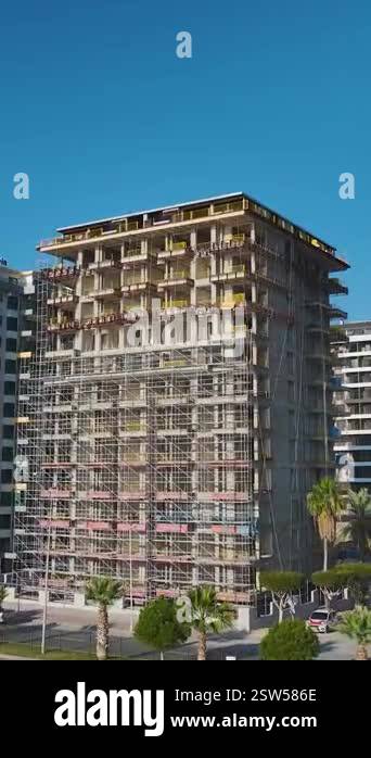 Image showcasing Future city skyline. Vertical footage of a high-rise under development ...