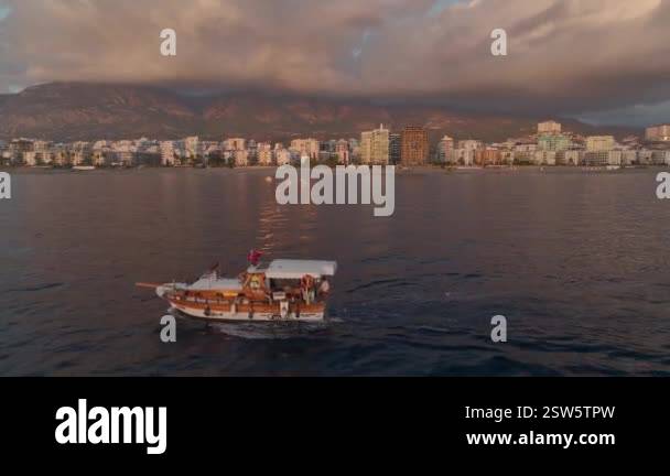 Sunset colors light up the fishing boat Stock Video Footage - Alamy