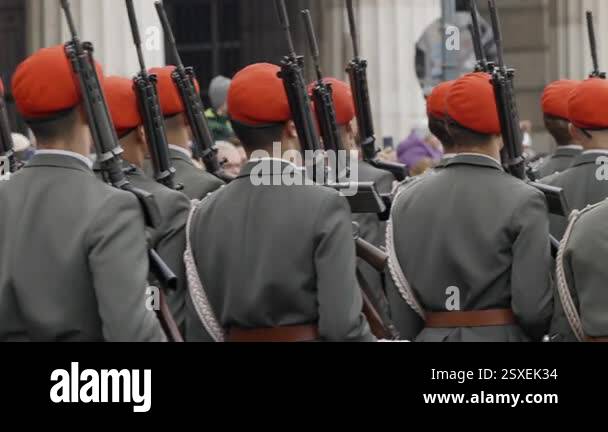 Machine Gun Walk Professional servicemen with machine guns walk on parade. Young ...