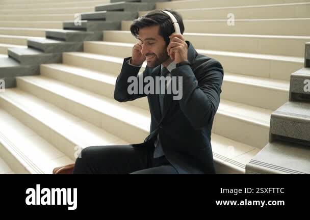 Closeup of professional business man enjoy to listen music by using ...