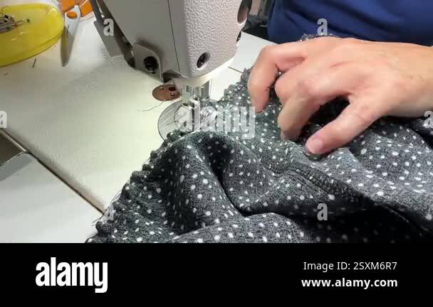 The process of sewing a dress. Close-up hands a seamstress guiding ...