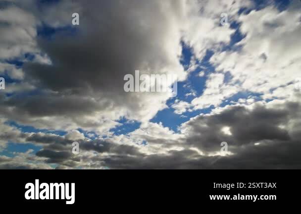 A timelapse of dramatic clouds shifting across the sky, revealing ...