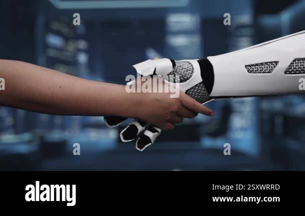 A close-up video depicting a handshake between a human and a robotic ...