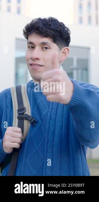 Happy hispanic student showing thumbs up sign of approval and success ...