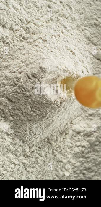 Super Slow Motion of Falling Raw Egg into Flour. Filmed on High Speed ...