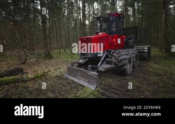 A robust red logging machine designed for timber transport in dense ...