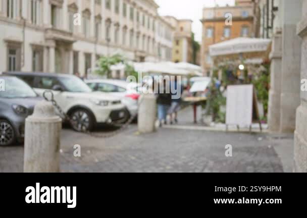 Blurred street scene in rome with people walking, surrounded by ...