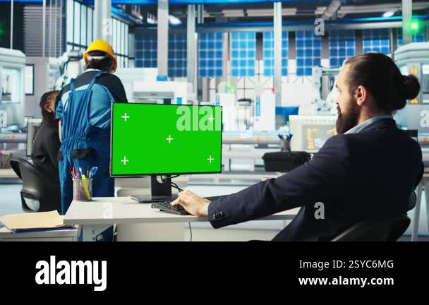 Photovoltaics factory worker analyzing data on green screen PC ...