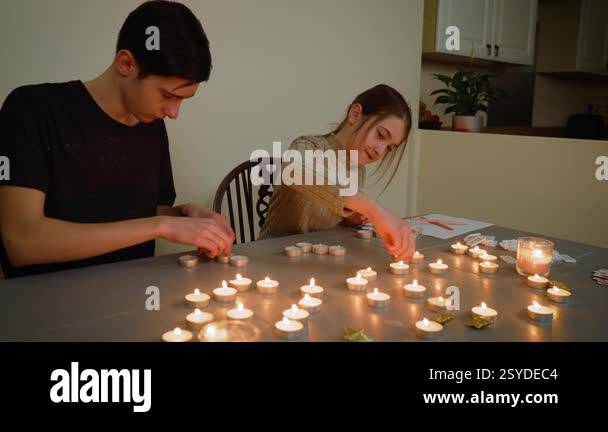 Spiritual children arranging candles for paranormal ritual. Brother and ...
