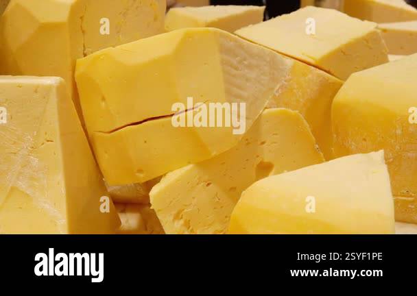Fresh blocks of cheese are showcased at a local market Stock Video ...