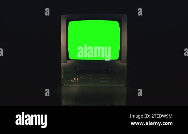 Vintage TV Green Screen in a dark room. Retro Television turning on ...